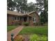 Charming brick home with a well-manicured lawn and a brick walkway leading to the front door at 600 Colby Cir, Salisbury, NC 28147