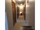Hallway featuring three wooden doors, neutral walls and carpet leading to bedrooms at 600 Colby Cir, Salisbury, NC 28147