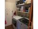 Convenient laundry room featuring modern washer and dryer on a tile floor with storage shelves at 600 Colby Cir, Salisbury, NC 28147
