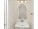 Half bathroom with a white sink, a mirror, and updated light fixtures at 6101 Heath Ridge Ct, Charlotte, NC 28210