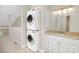Convenient upstairs bathroom with stacked washer and dryer near sink at 6101 Heath Ridge Ct, Charlotte, NC 28210