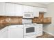 Well-lit kitchen features white cabinetry, stainless steel appliances, and sleek granite countertops at 6101 Heath Ridge Ct, Charlotte, NC 28210
