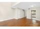 Bright living room with wood floors, staircase, and an entrance to the kitchen at 6101 Heath Ridge Ct, Charlotte, NC 28210