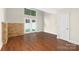 Inviting living room with a stone accent wall, wood floors, and a French door at 6101 Heath Ridge Ct, Charlotte, NC 28210