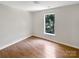 Bedroom with hardwood floors and a large window at 6413 Fillian Ln, Charlotte, NC 28269