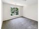 Clean, carpeted bedroom with a large window offering natural light at 6413 Fillian Ln, Charlotte, NC 28269