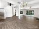 Open-concept living room with hardwood floors, high ceilings, and bright sunlight at 6413 Fillian Ln, Charlotte, NC 28269