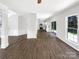 Open-concept living room featuring hardwood floors and views into kitchen at 6413 Fillian Ln, Charlotte, NC 28269