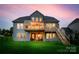 Spacious backyard featuring a large deck with lighting, outdoor seating, and a lush lawn at 7026 Wyngate Pl, Lancaster, SC 29720
