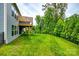 Expansive backyard with lush green lawn, mature trees, and stairway to the deck at 7026 Wyngate Pl, Lancaster, SC 29720