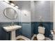 Stylish powder room featuring blue wainscoting, patterned wallpaper, and a round mirror at 7026 Wyngate Pl, Lancaster, SC 29720