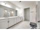 Large bathroom featuring double vanity sinks, white marble floors, and a large amount of cabinet space at 7026 Wyngate Pl, Lancaster, SC 29720