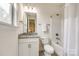 Clean bathroom features a granite-topped vanity, a tub with shower, and a bright, inviting ambiance at 7026 Wyngate Pl, Lancaster, SC 29720