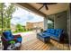 Relaxing covered deck features comfortable seating, ceiling fan, and outdoor grill at 7026 Wyngate Pl, Lancaster, SC 29720