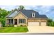 Charming brick home featuring a well-manicured lawn, inviting front porch, and a spacious three-car garage at 7026 Wyngate Pl, Lancaster, SC 29720