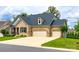 Attractive brick home with a well-manicured lawn, three-car garage, and inviting entrance at 7026 Wyngate Pl, Lancaster, SC 29720