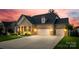 Charming brick home featuring a well-manicured lawn, inviting front porch, and a spacious three-car garage at 7026 Wyngate Pl, Lancaster, SC 29720