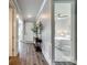 Bright hallway with hardwood floors, wainscoting detail, and view of bedroom at 7026 Wyngate Pl, Lancaster, SC 29720