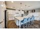 A modern kitchen featuring a large island with seating, stainless steel appliances, and elegant pendant lighting at 7026 Wyngate Pl, Lancaster, SC 29720
