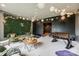 Spacious living room features unique green wall, playful lighting and foosball table at 7026 Wyngate Pl, Lancaster, SC 29720
