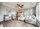 Spacious living room features a tray ceiling, modern furniture, and seamless flow to the adjacent spaces at 7026 Wyngate Pl, Lancaster, SC 29720