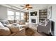 Cozy living room with a fireplace, built-in shelves, and comfortable seating, perfect for relaxation and entertainment at 7026 Wyngate Pl, Lancaster, SC 29720