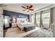 Relaxing main bedroom with a large bed, soft carpeting, and bright windows, creating a serene retreat at 7026 Wyngate Pl, Lancaster, SC 29720