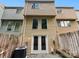 Exterior backyard view of the townhome featuring light wood siding and a privacy fence at 7609 Holly Grove Ct, Charlotte, NC 28227