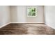 Bright, airy bedroom with ample natural light, laminate floors, and neutral wall paint at 7609 Holly Grove Ct, Charlotte, NC 28227