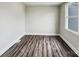 Cozy room with hardwood floors, white trim, and a bright window at 7609 Holly Grove Ct, Charlotte, NC 28227
