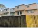 Charming townhome exterior featuring wood-look siding, fenced yard, and a welcoming facade at 7609 Holly Grove Ct, Charlotte, NC 28227