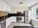 Modern kitchen featuring white cabinets, stainless steel appliances, and granite countertops at 7609 Holly Grove Ct, Charlotte, NC 28227