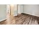 Spacious living room featuring hardwood flooring, neutral paint, and open layout at 7609 Holly Grove Ct, Charlotte, NC 28227