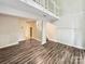 Open-concept living room with hardwood flooring, white trim, and a fireplace at 7609 Holly Grove Ct, Charlotte, NC 28227