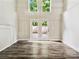 Bright living room with high ceilings, french doors, and dark wood flooring at 7609 Holly Grove Ct, Charlotte, NC 28227