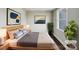 Comfortable bedroom with hardwood floors, neutral colors, and large decorative paintings at 7609 Holly Grove Ct, Charlotte, NC 28227