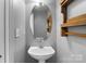 Stylish bathroom featuring a pedestal sink and a wooden accent piece at 7943 Mariners Pointe Cir, Denver, NC 28037