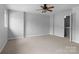 A bright bedroom includes carpet, ceiling fan and access to an ensuite bathroom at 7943 Mariners Pointe Cir, Denver, NC 28037