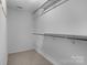 An organized walk-in closet has built-in shelving and a clean, functional space at 7943 Mariners Pointe Cir, Denver, NC 28037