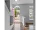Inviting foyer with stylish flooring, staircase, and abundant natural light at 7943 Mariners Pointe Cir, Denver, NC 28037