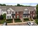 A three-story townhouse boasts brick and siding, neat landscaping, and convenient parking at 7943 Mariners Pointe Cir, Denver, NC 28037