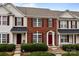 Charming townhome featuring brick facade, burgundy shutters, and well-maintained landscaping at 7943 Mariners Pointe Cir, Denver, NC 28037