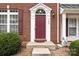 A close up of the front door with brick facade and classic white trim at 7943 Mariners Pointe Cir, Denver, NC 28037
