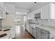 Bright kitchen featuring white cabinets, granite countertops, and stainless steel appliances at 7943 Mariners Pointe Cir, Denver, NC 28037