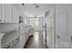 Modern kitchen featuring white cabinets, stainless steel appliances, and hardwood floors at 7943 Mariners Pointe Cir, Denver, NC 28037