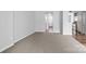 Open-concept living room with neutral carpet and view to kitchen at 7943 Mariners Pointe Cir, Denver, NC 28037