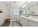 Modern bathroom with double vanity, sleek fixtures, glass shower and gray wood-look flooring at 829 Sedgefield Rd, Charlotte, NC 28209