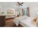 Bright bedroom featuring a ceiling fan, light hardwood floors, and a neutral color palette at 829 Sedgefield Rd, Charlotte, NC 28209