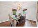 Bright dining room featuring modern light fixture, hardwood floors, and stylish decor at 829 Sedgefield Rd, Charlotte, NC 28209