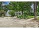 Charming home featuring lush landscaping, a circular driveway, and meticulously manicured yard at 829 Sedgefield Rd, Charlotte, NC 28209